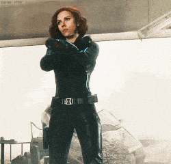 Character in black suit, striking pose.