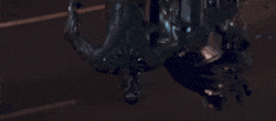 Character hanging upside down, dramatic scene.
