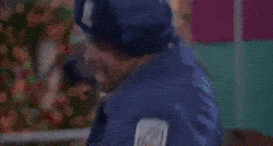 Person in blue uniform celebrating joyfully