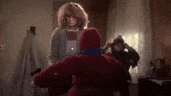 Child in red coat, indoor scene.