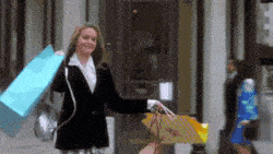 Woman shopping with multiple bags.