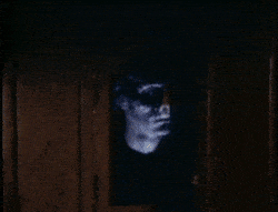 Eerie face appearing from darkness