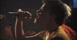 Person performing on stage passionately.