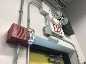 Exit sign with emergency lights and alarm