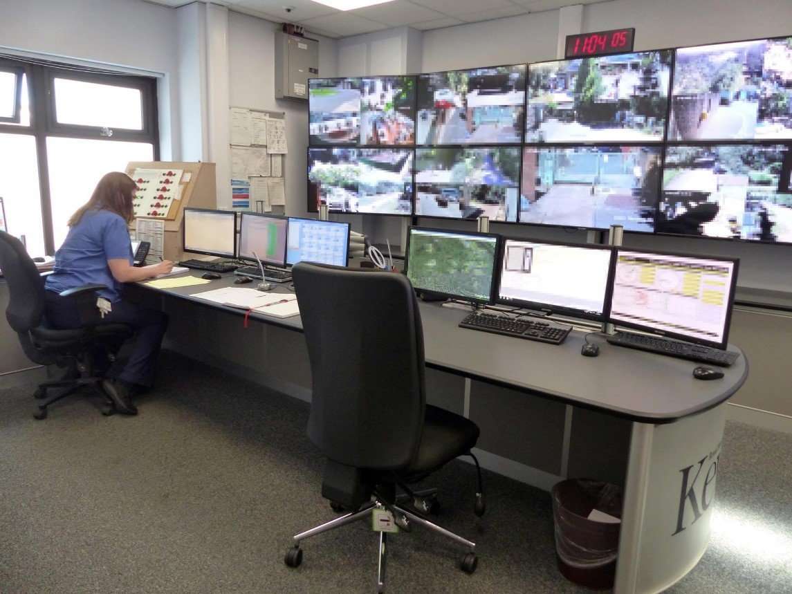 Surveillance room with multiple monitors.