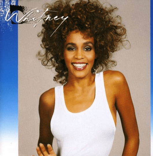Model with curly hair in white tank