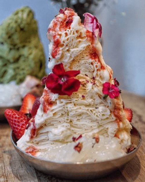 Layered dessert with flowers and strawberries