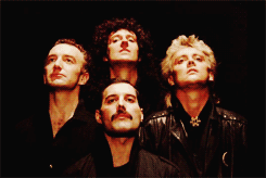 Four individuals in dark clothing.