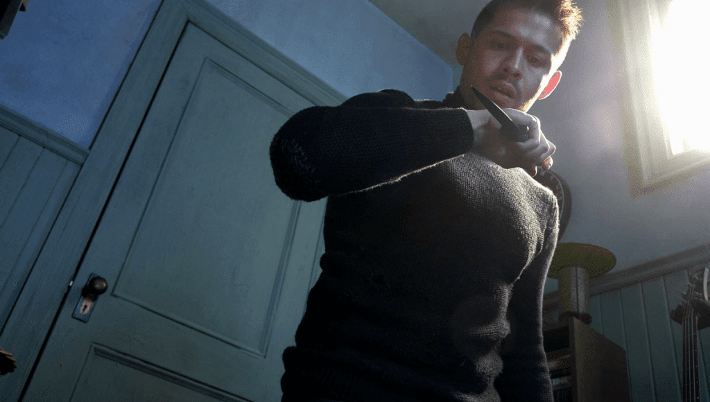 Person holding an object in room.