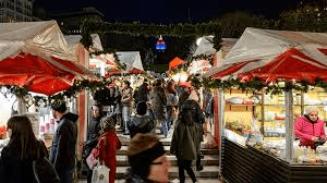 Busy market with festive decorations.