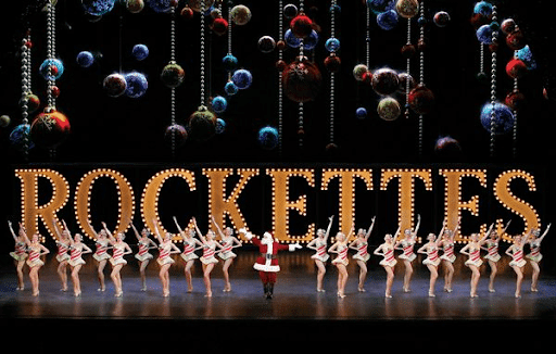 Rockettes performing with festive backdrop